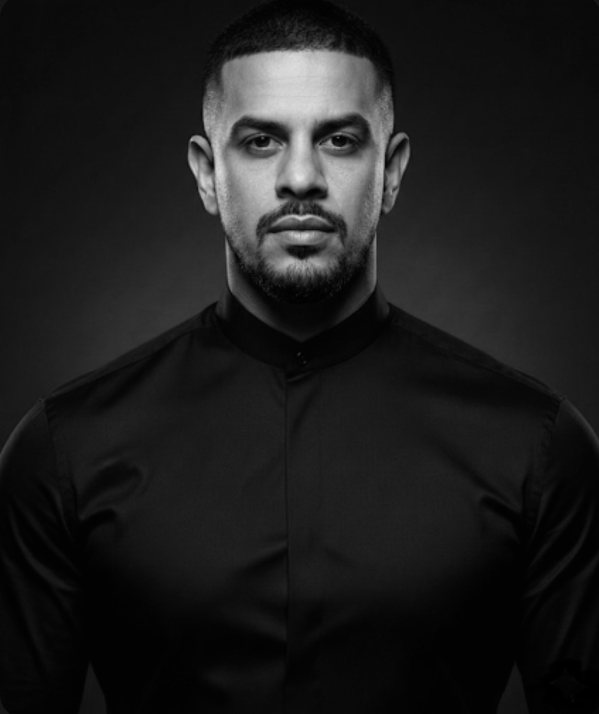 Black and white portrait of Angelo Garsant wearing a black shirt